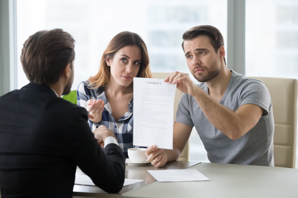 Young couple is dissatisfied with terms of contract